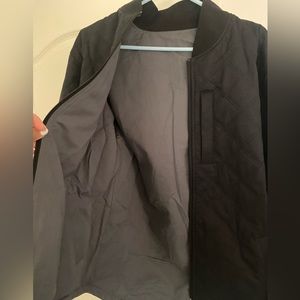 Bylt Basics Hi-Lo Reversible Bomber Jacket. One size is black and one is gray.